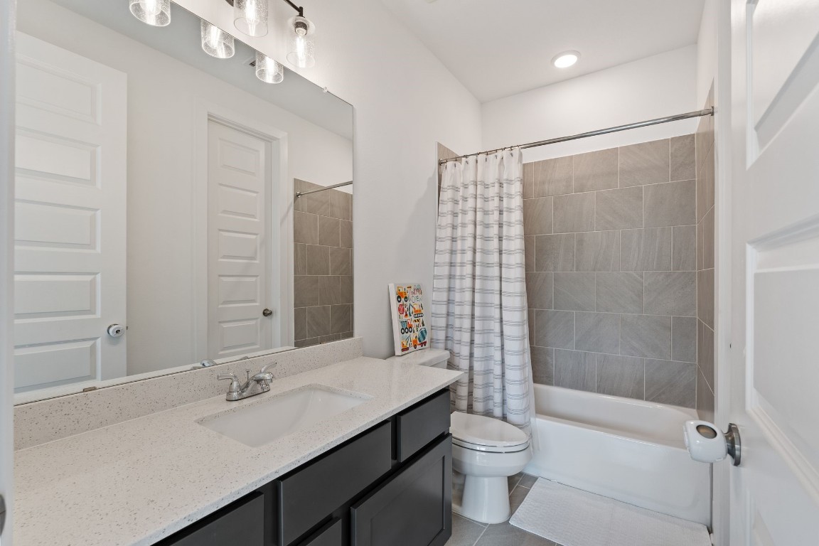 914 Sendero Trail Conroe, TX 77304 - Photo 27 of 50 a bathroom with a double vanity sink toilet mirror and shower