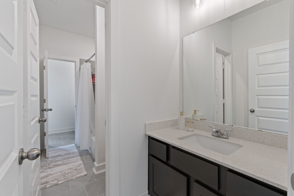 914 Sendero Trail Conroe, TX 77304 - Photo 34 of 50 a bathroom with a sink and a mirror