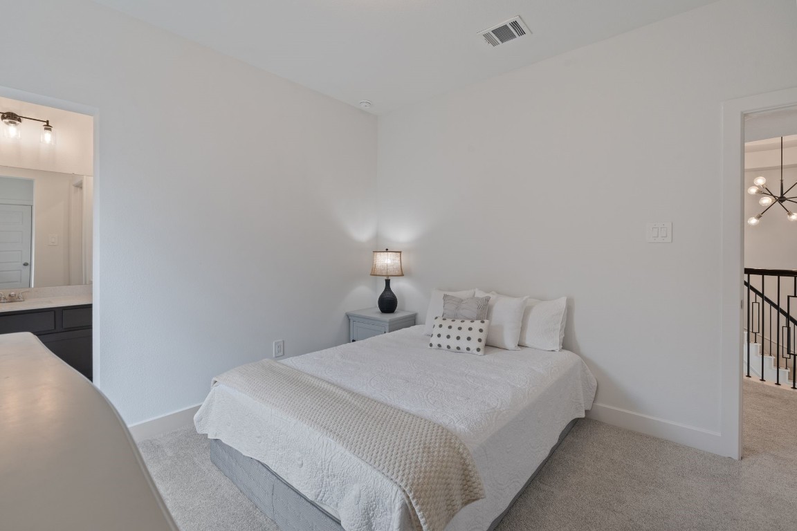 914 Sendero Trail Conroe, TX 77304 - Photo 37 of 50 a bedroom with a bed and a night stand