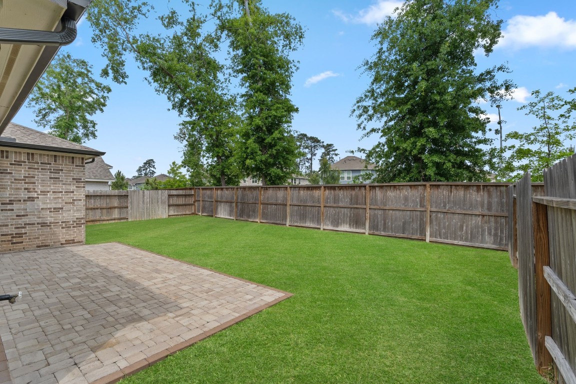914 Sendero Trail Conroe, TX 77304 - Photo 42 of 50 a view of a backyard with a garden