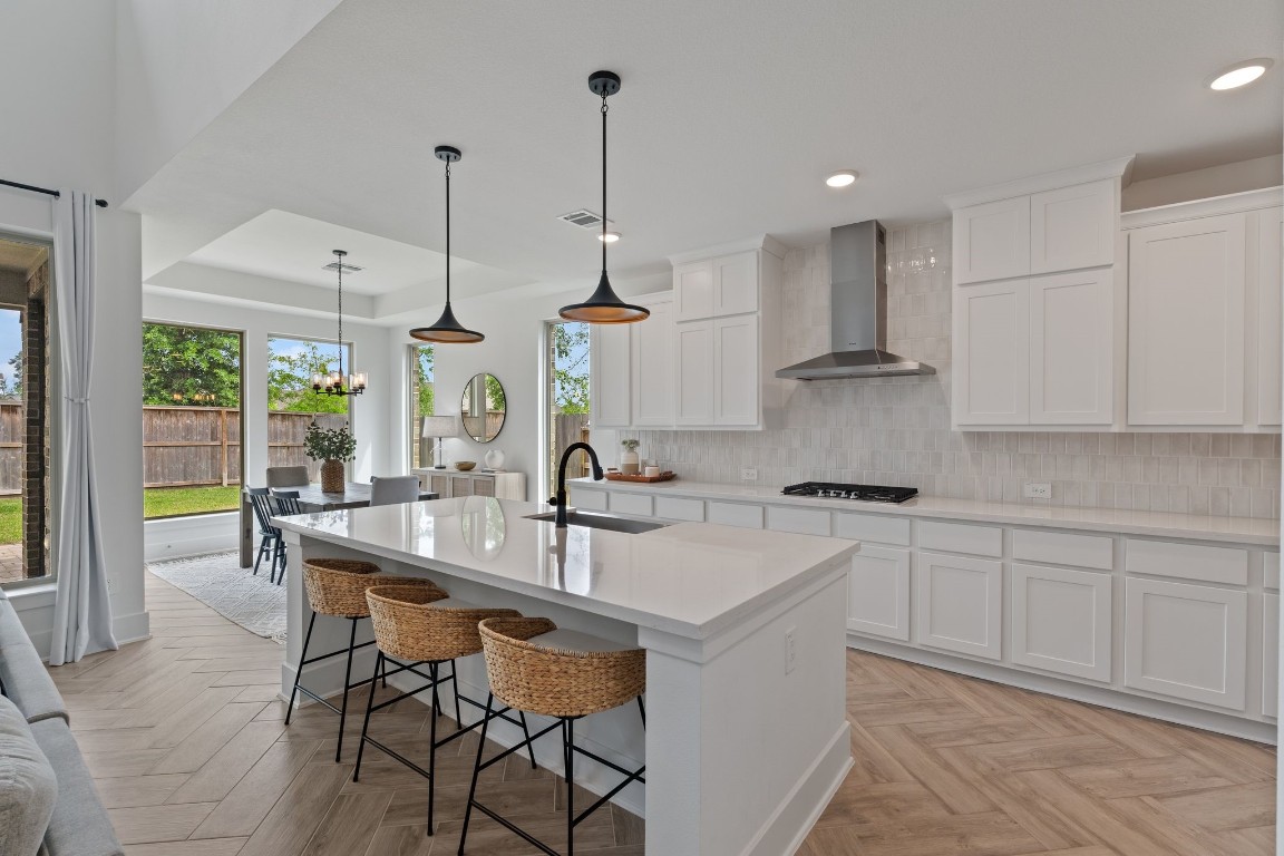 914 Sendero Trail Conroe, TX 77304 - Photo 10 of 50 a kitchen with stainless steel appliances granite countertop a sink a stove and a wooden floors