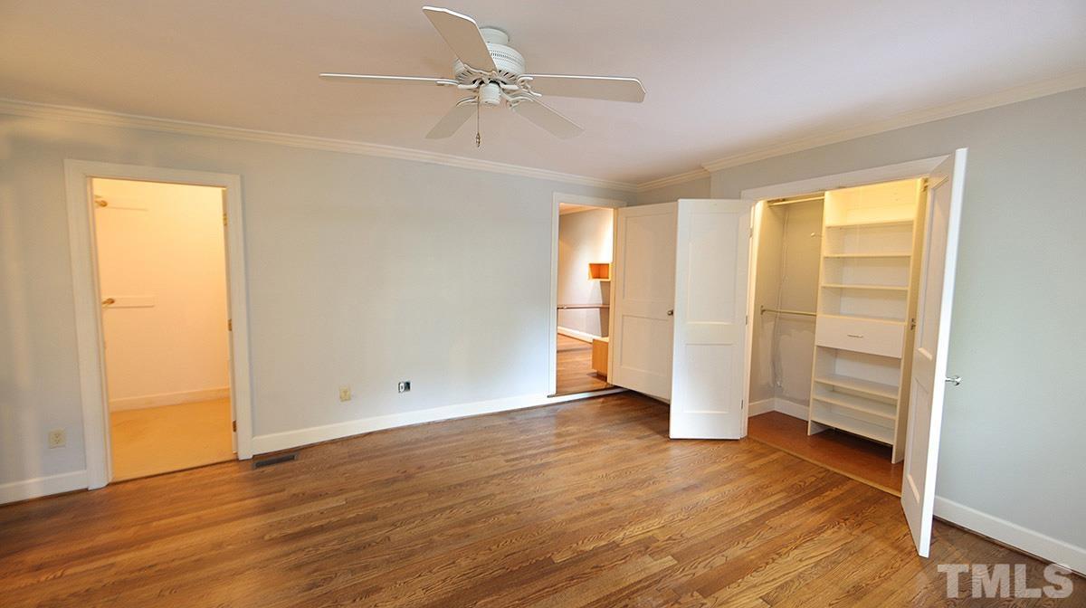 829 Runnymede Road Raleigh, NC 27607 - Photo 17 of 29 an empty room with wooden floor closet and windows