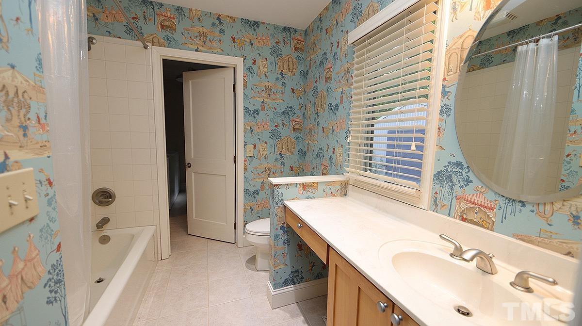 829 Runnymede Road Raleigh, NC 27607 - Photo 22 of 29 a bathroom with a tub sink and mirror
