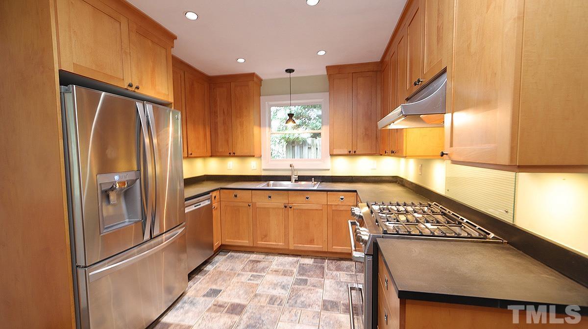 829 Runnymede Road Raleigh, NC 27607 - Photo 8 of 29 a kitchen with stainless steel appliances granite countertop a refrigerator and a sink