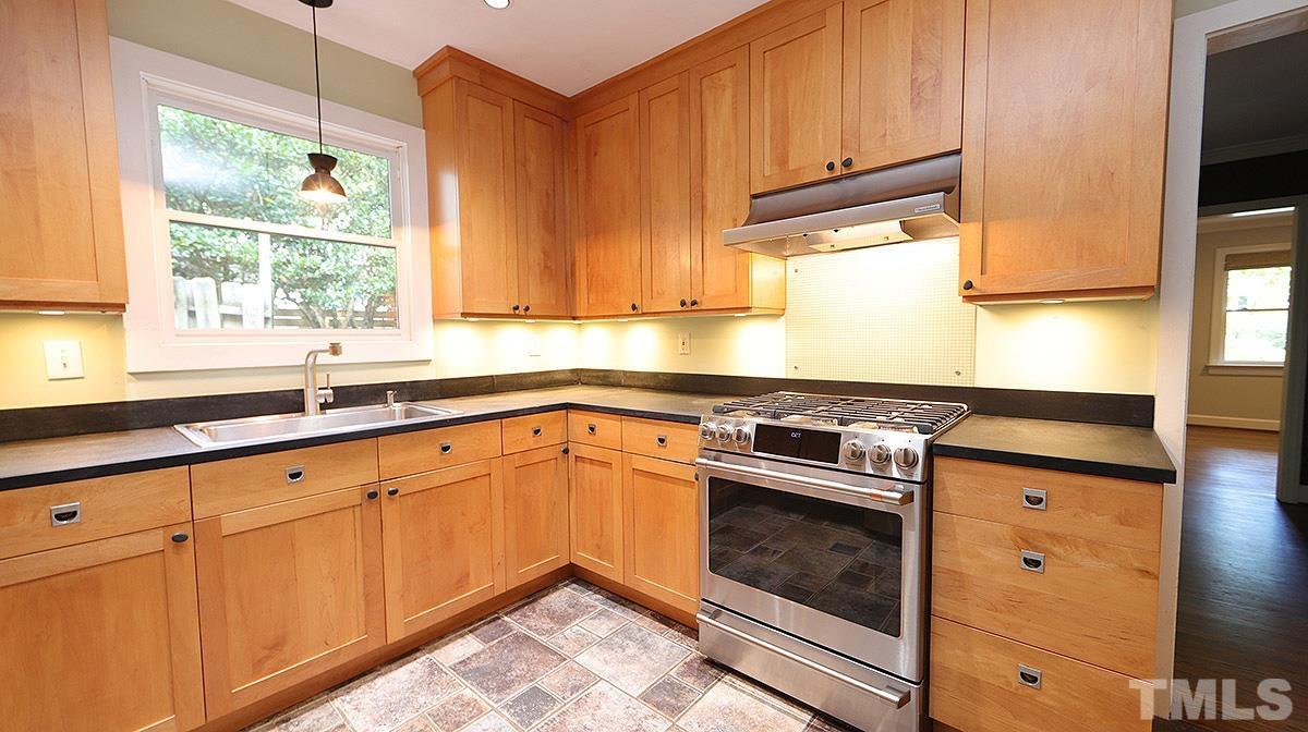 829 Runnymede Road Raleigh, NC 27607 - Photo 9 of 29 a kitchen with granite countertop a sink stainless steel appliances and cabinets
