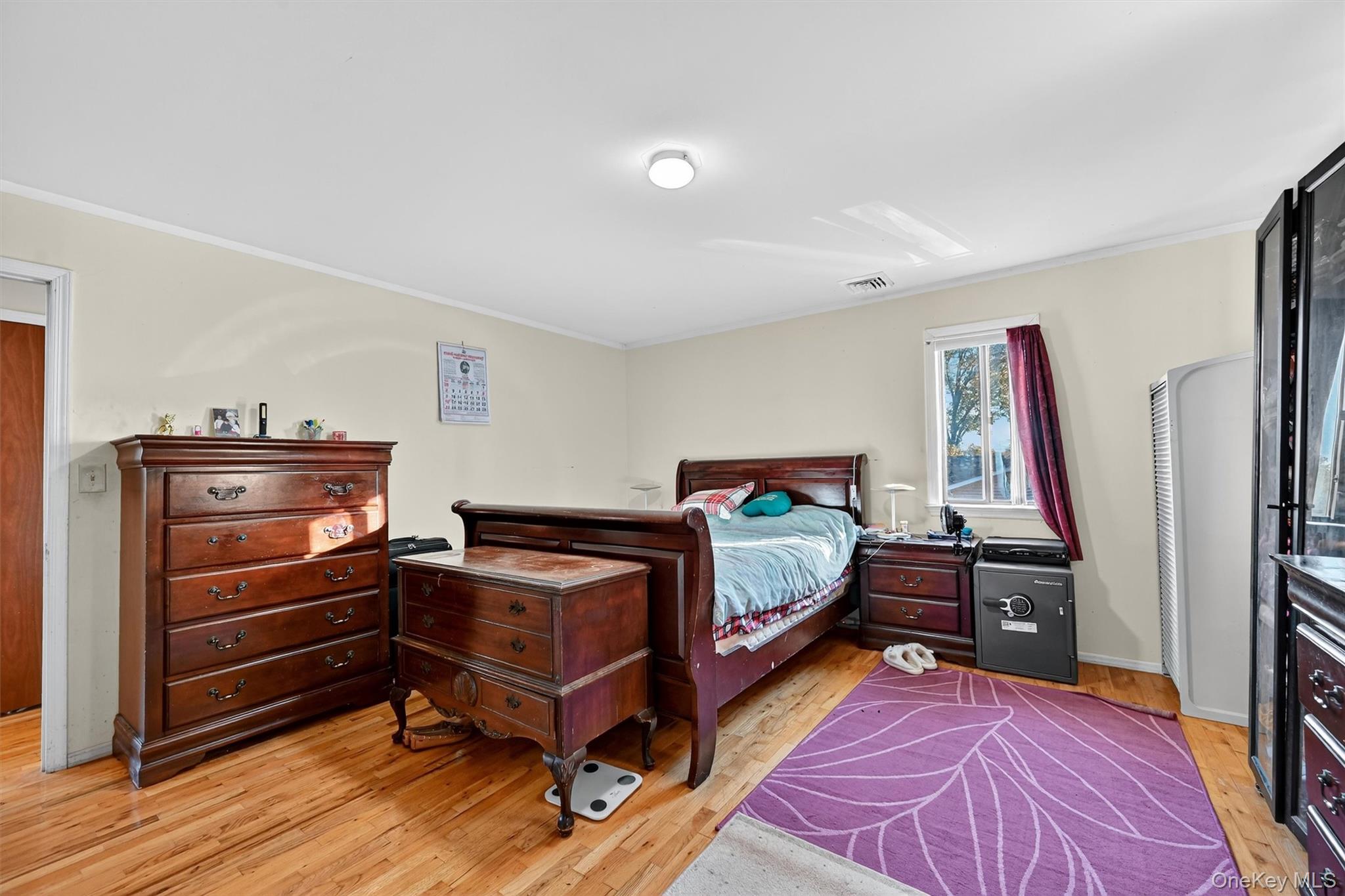 5 Schettig Court Spring Valley, NY 10977 - Photo 12 of 26 a bedroom with furniture and a wooden floor