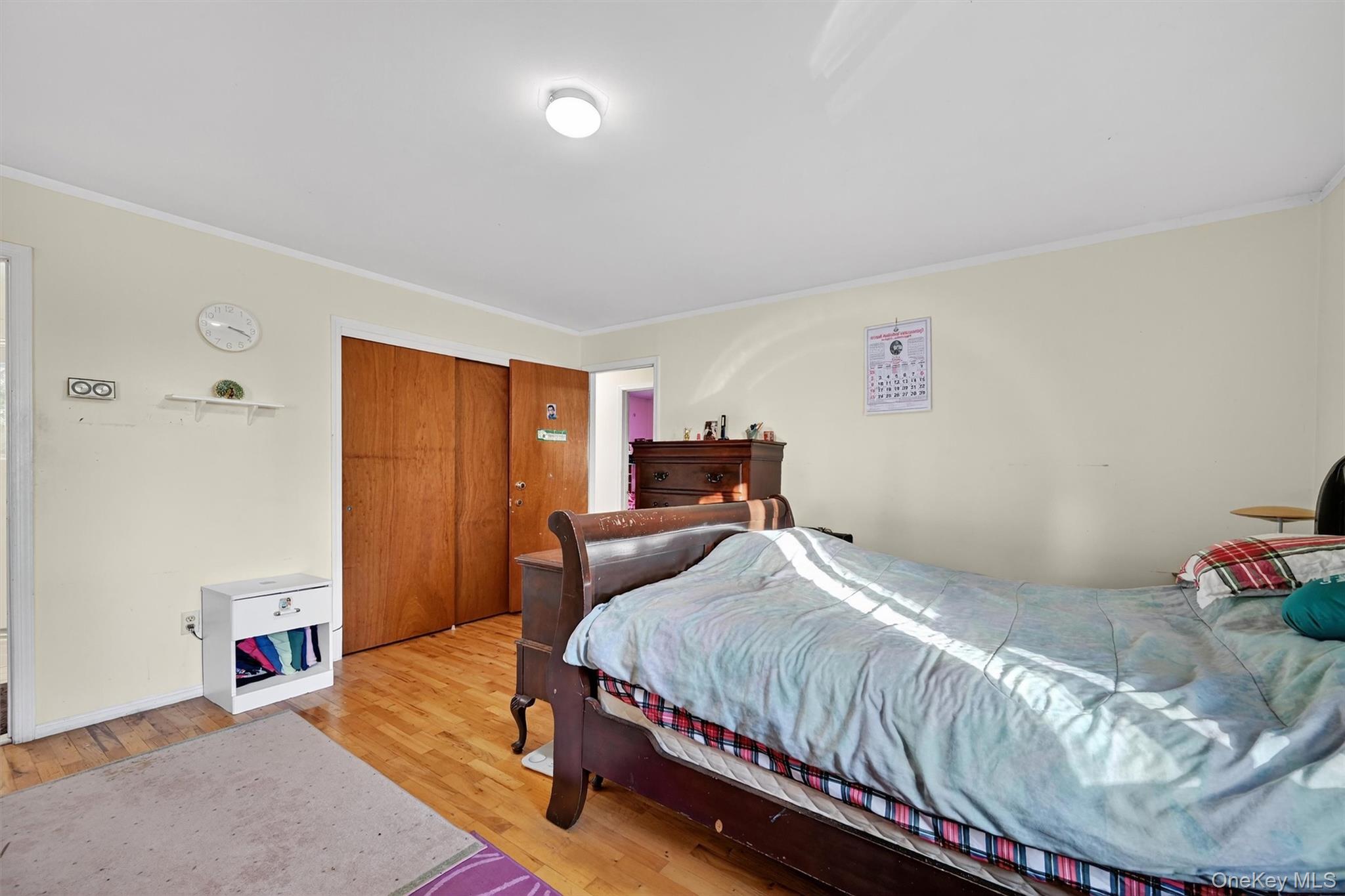 5 Schettig Court Spring Valley, NY 10977 - Photo 13 of 26 a bedroom with a bed and a window