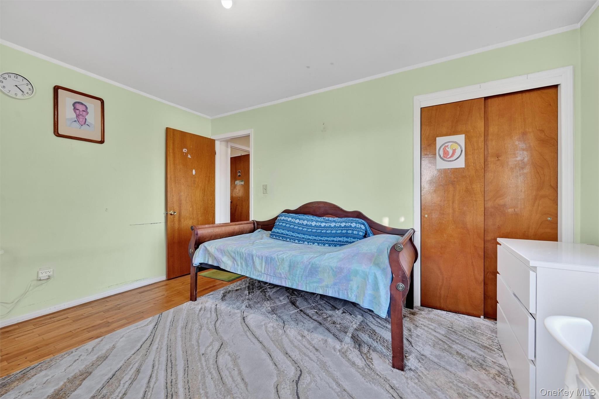 5 Schettig Court Spring Valley, NY 10977 - Photo 16 of 26 a bedroom with a bed and a table in it