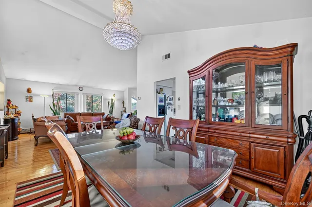 a view of a dining room with furniture a chandelier and wooden floor
