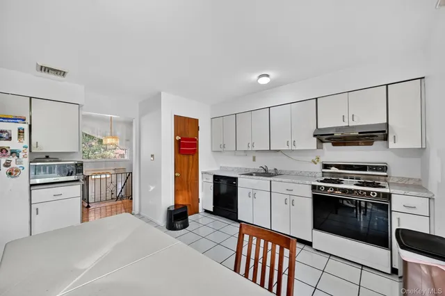 a kitchen with stainless steel appliances granite countertop a stove top oven a refrigerator a sink and dishwasher