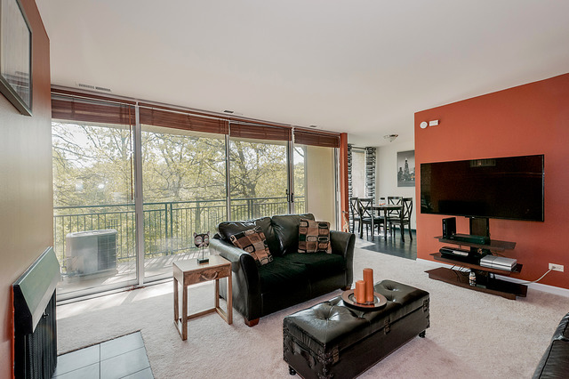 6017 Forest View Road, Unit 2C Lisle, IL 60532 - Photo 3 of 10 a living room with furniture and a flat screen tv
