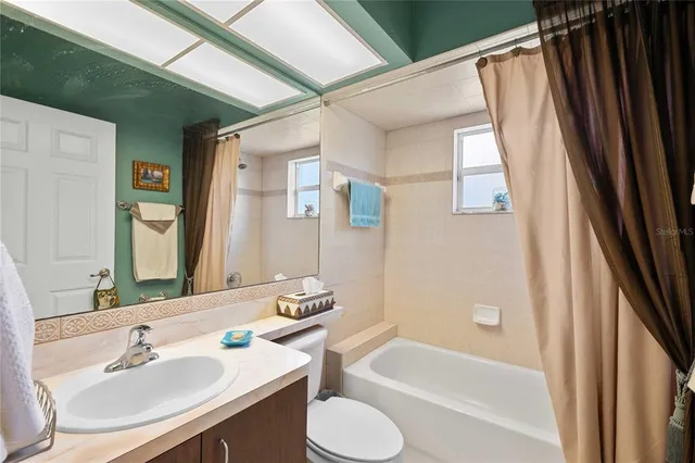 a view of house with a yard and potted plants