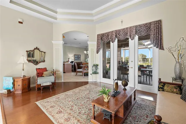 a view of a dining room with furniture and chandelier