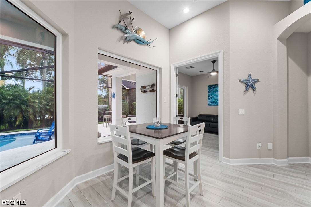 9042 Bronco Court Naples, FL 34113 - Photo 10 of 50 a dining room with furniture and window