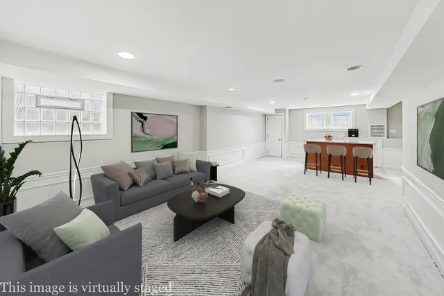 a living room with furniture and a dining table with kitchen view