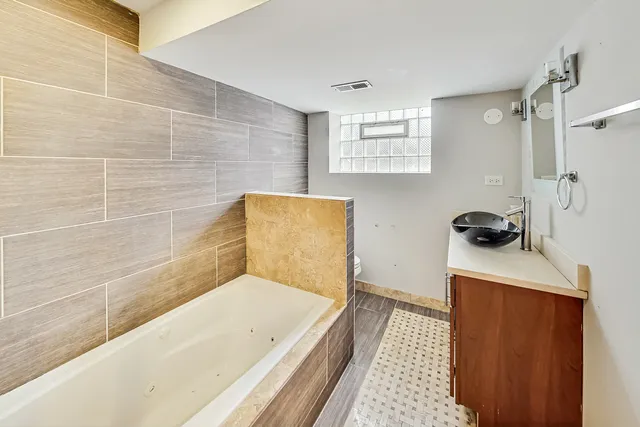 a bathroom with a bathtub and a shower