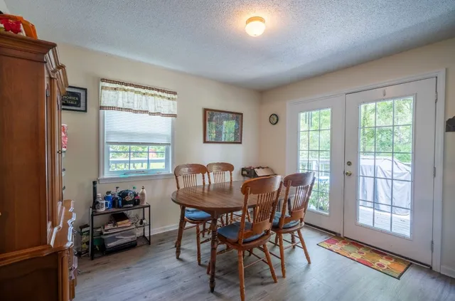 a view of a dining room with furniture and a window