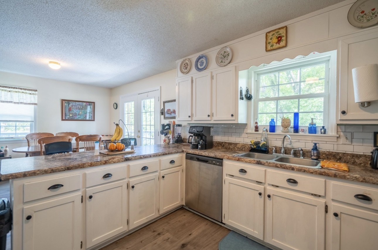 652 Old Florence Pulaski Road Leoma, TN 38468 - Photo 16 of 35 a kitchen with white cabinets and white appliances