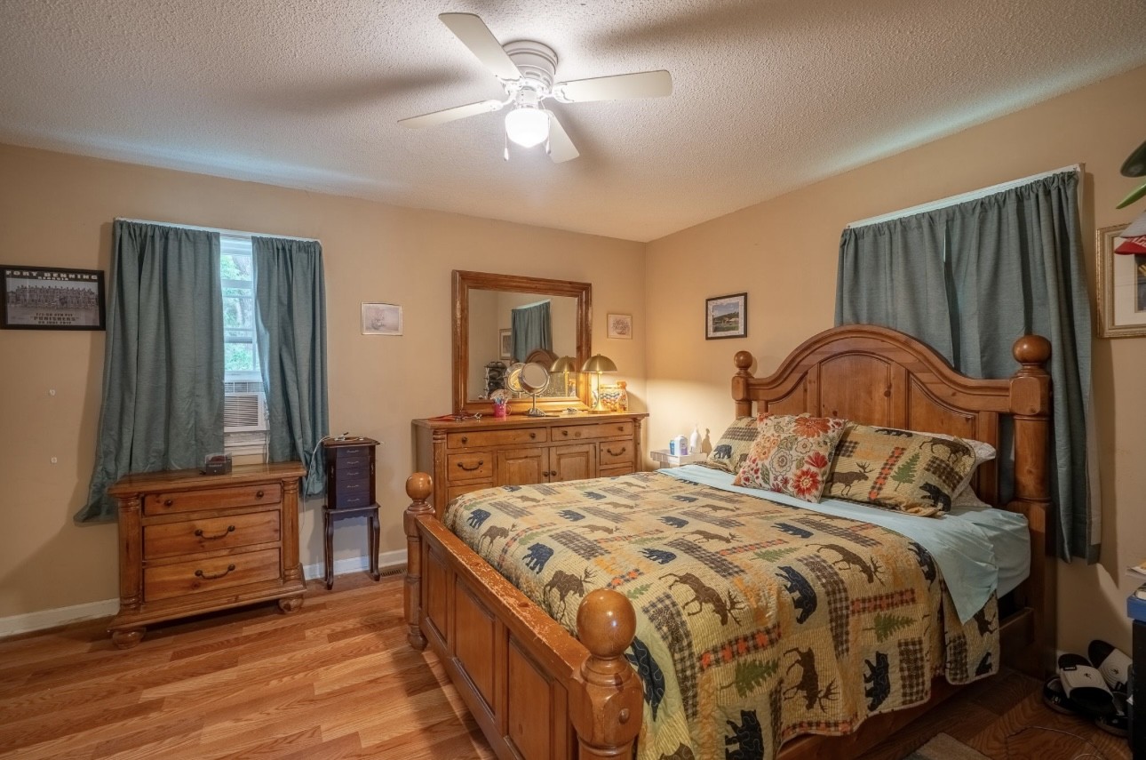 652 Old Florence Pulaski Road Leoma, TN 38468 - Photo 18 of 35 a bedroom with a bed and wooden floor