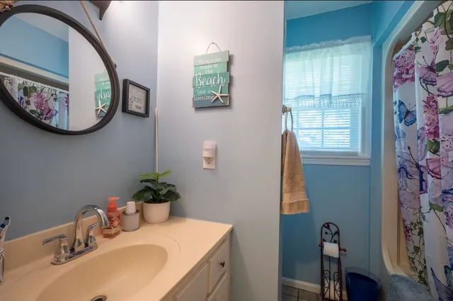 a bathroom with a sink mirror and vanity