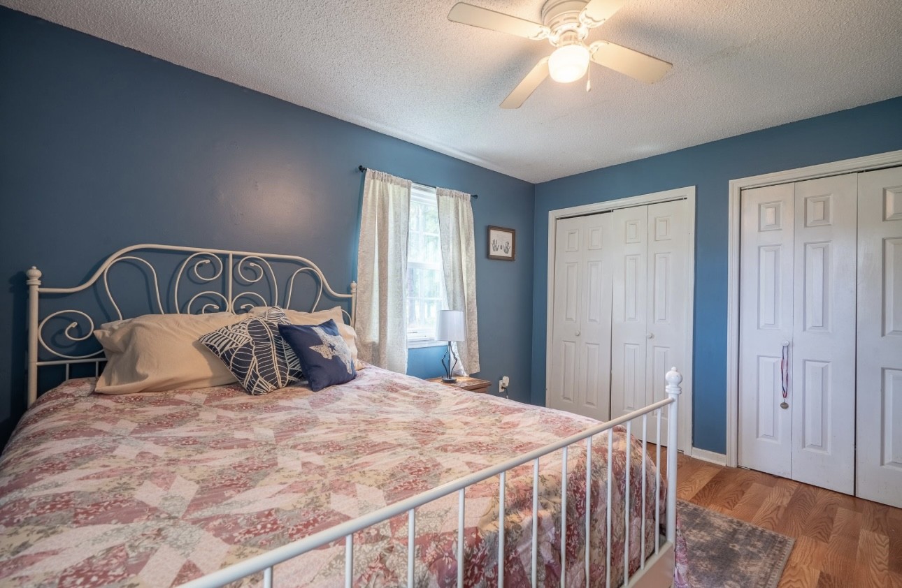 652 Old Florence Pulaski Road Leoma, TN 38468 - Photo 22 of 35 a bedroom with a large bed and a chandelier