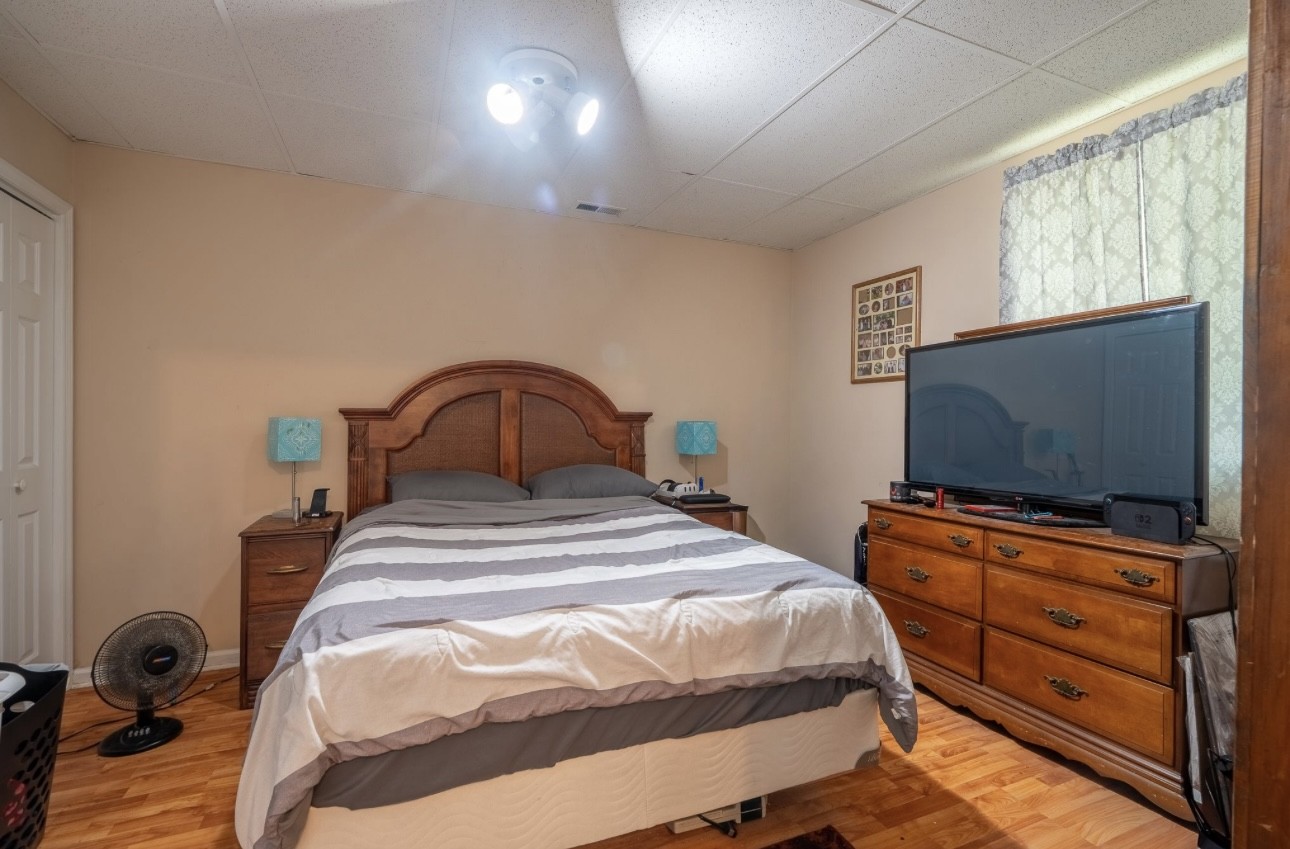 652 Old Florence Pulaski Road Leoma, TN 38468 - Photo 25 of 35 a bedroom with a bed and a flat screen tv