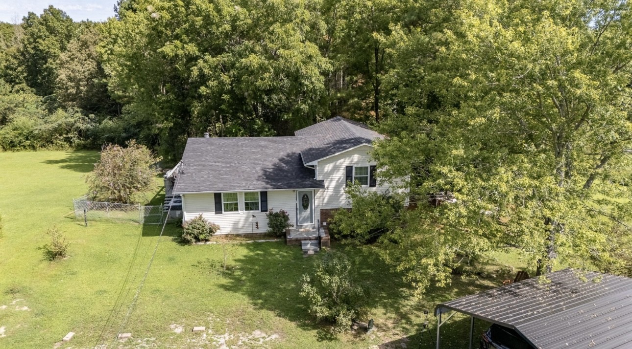 652 Old Florence Pulaski Road Leoma, TN 38468 - Photo 26 of 35 a aerial view of a house with swimming pool next to a yard