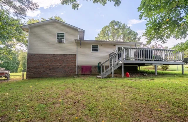 a view of a house with a yard and sitting area