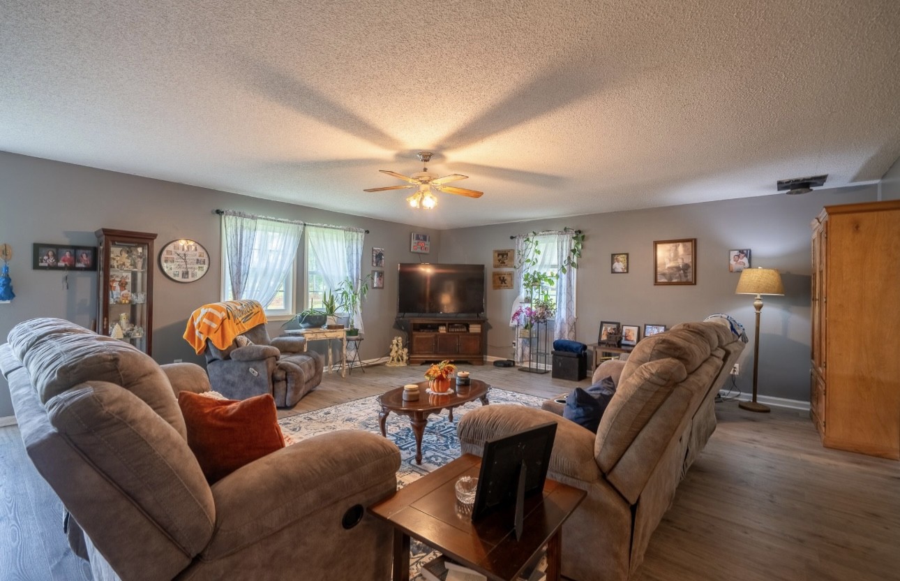 652 Old Florence Pulaski Road Leoma, TN 38468 - Photo 10 of 35 a living room with furniture a desk and chair with wooden floor