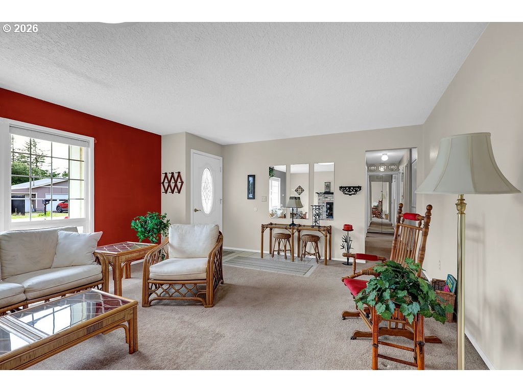 1415 20th Street Florence, OR 97439 - Photo 4 of 40 a living room with furniture and a dining table with kitchen view