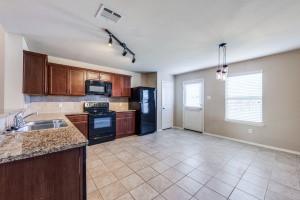1275 Ophelia Road Forney, TX 75126 - Photo 4 of 10 a kitchen with stainless steel appliances granite countertop a sink refrigerator and cabinets