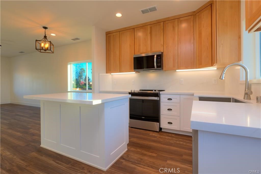 5485 South Libby Road Paradise, CA 95969 - Photo 3 of 6 a kitchen with stainless steel appliances a stove microwave and cabinets