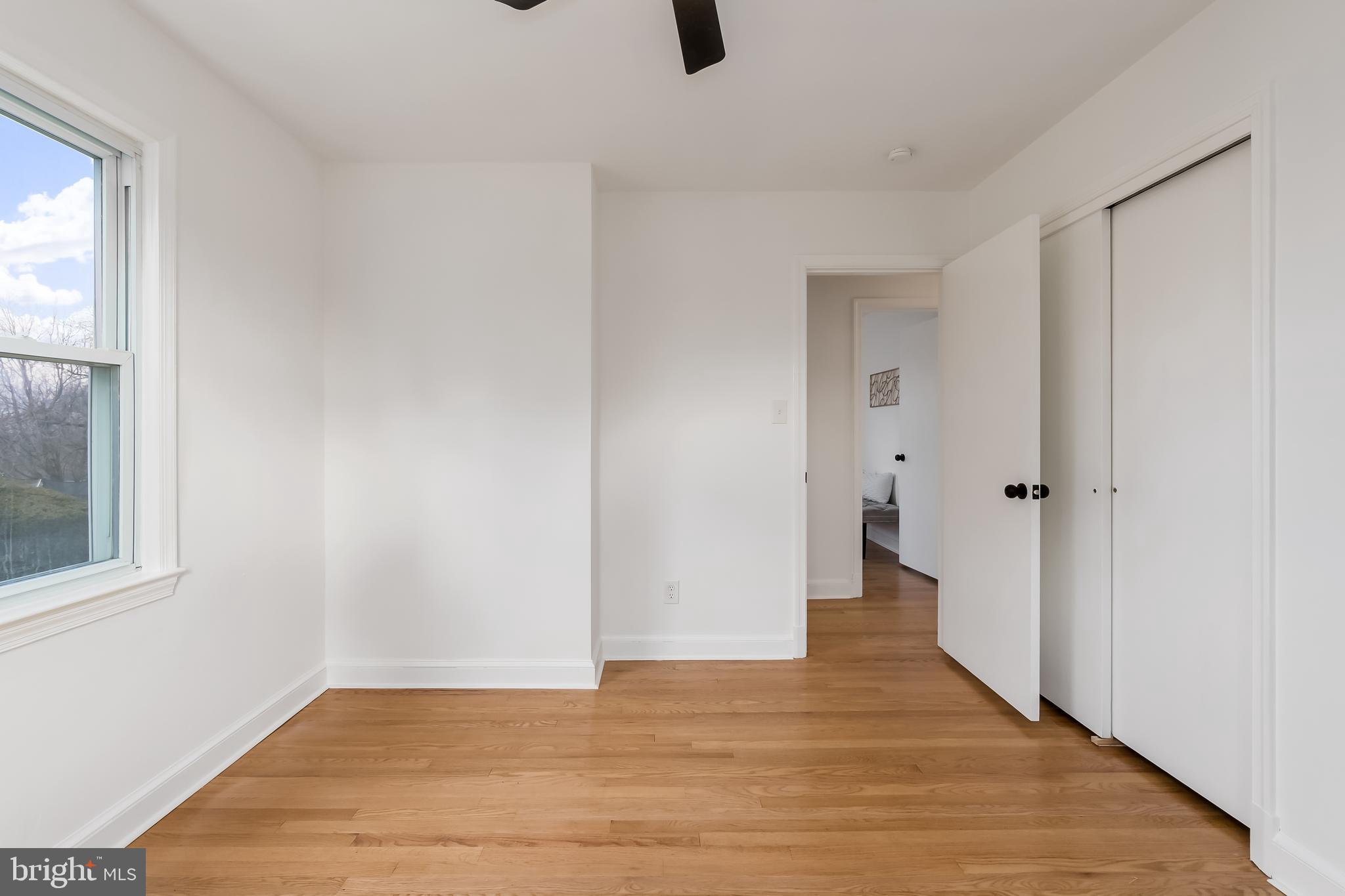 10319 Bethesda Church Road Damascus, MD 20872 - Photo 15 of 41 a view of an empty room with wooden floor and a window