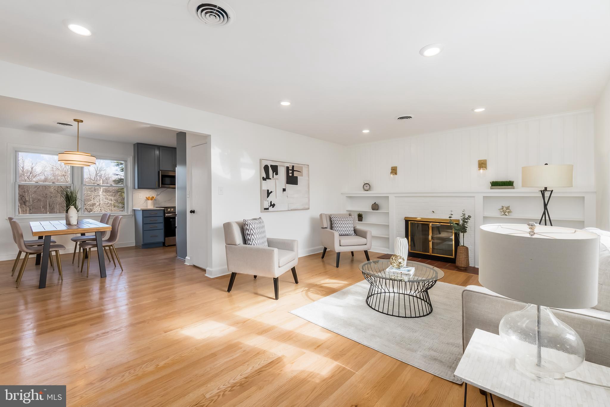 10319 Bethesda Church Road Damascus, MD 20872 - Photo 3 of 41 a living room with furniture and a dining table with kitchen view