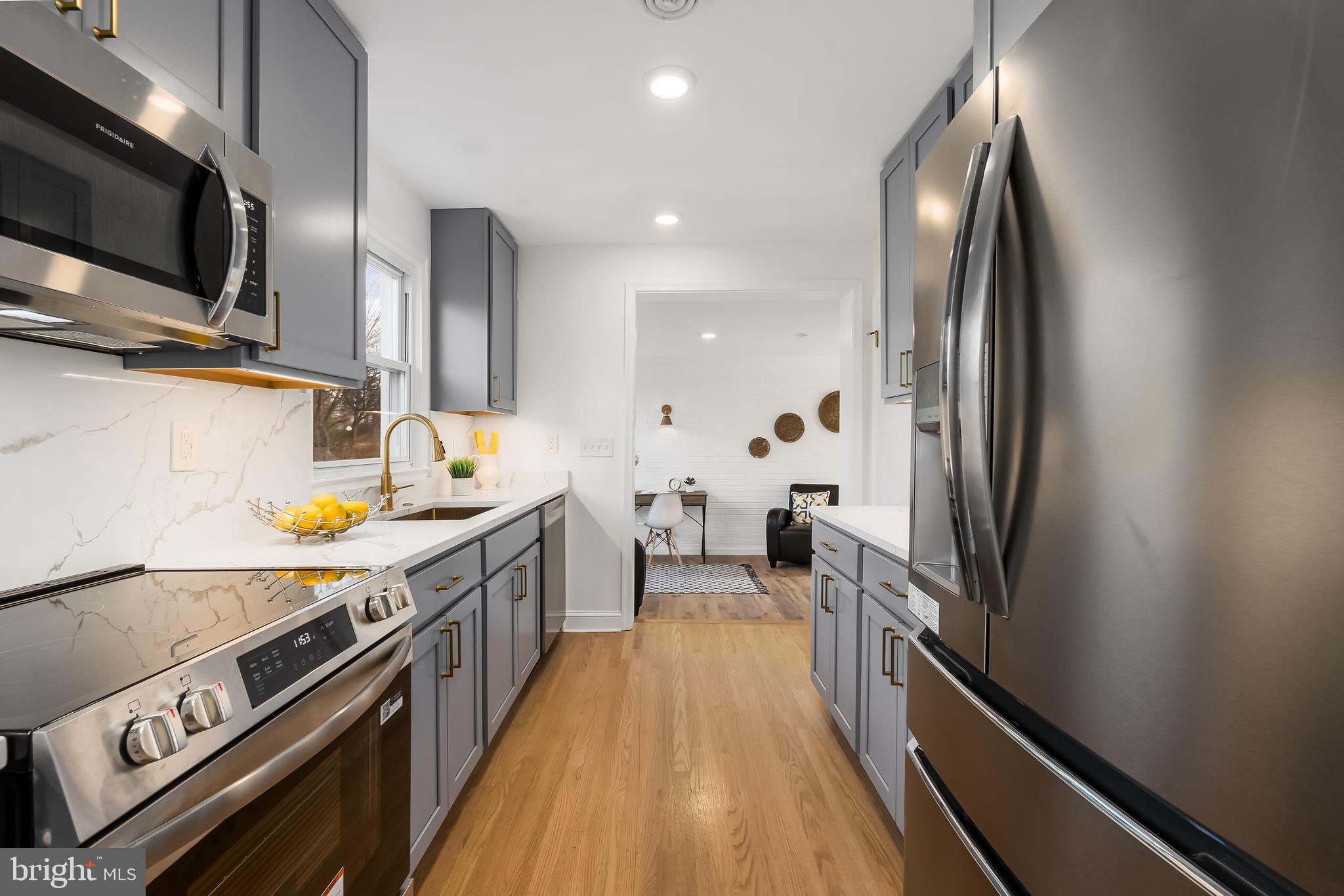 10319 Bethesda Church Road Damascus, MD 20872 - Photo 6 of 41 a kitchen with stainless steel appliances a sink stove and refrigerator