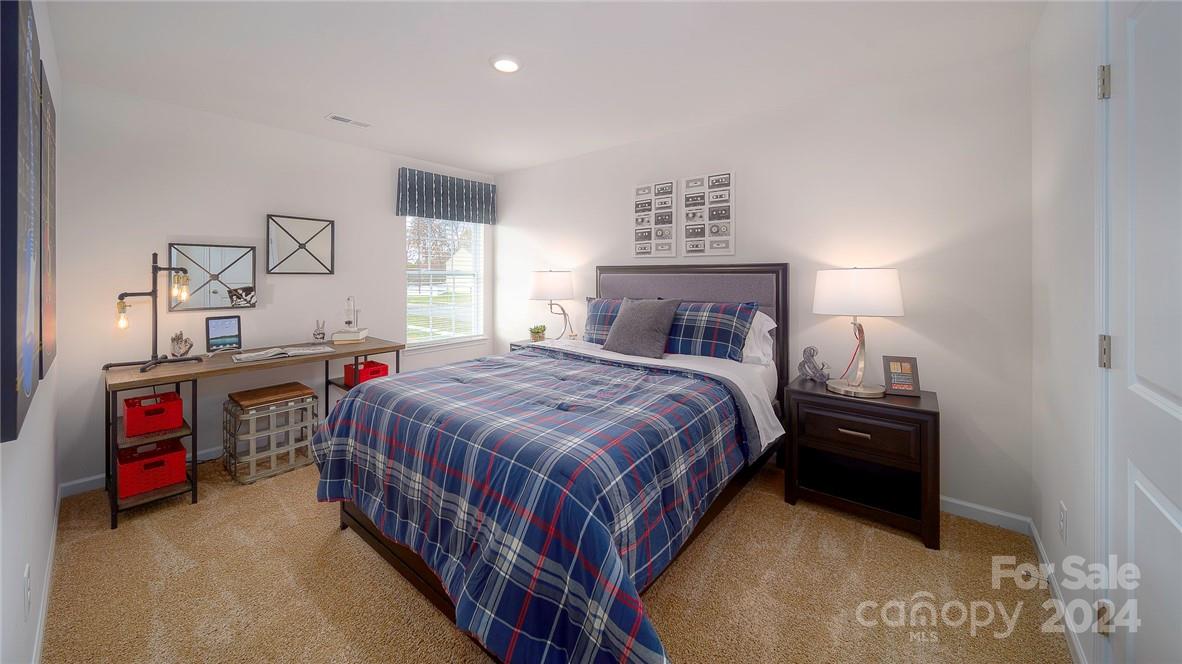 3627 Azalea Rdg Drive Mount Holly, NC 28120 - Photo 29 of 34 a bedroom with a bed and a chandelier