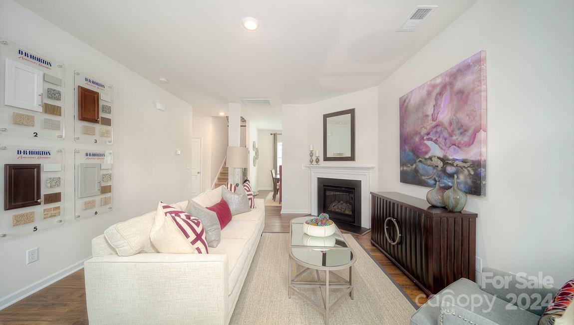 3627 Azalea Rdg Drive Mount Holly, NC 28120 - Photo 3 of 34 a living room with furniture a fireplace and a flat screen tv