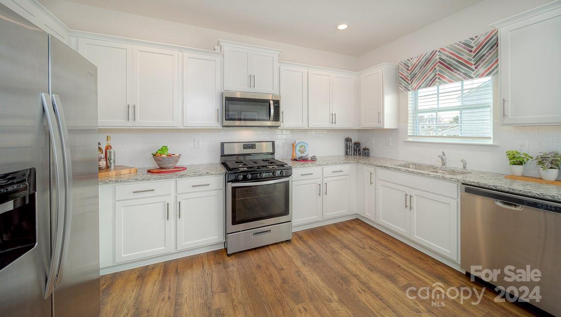 3627 Azalea Rdg Drive Mount Holly, NC 28120 - Photo 10 of 34 a kitchen with granite countertop white cabinets and white appliances