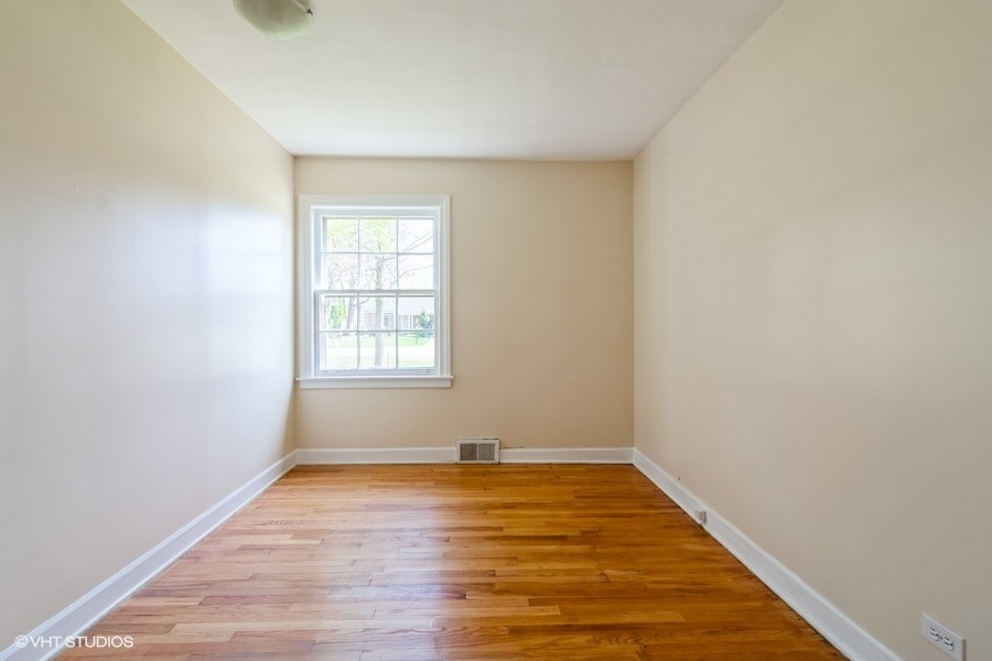 314 Wagner Road Northfield, IL 60093 - Photo 14 of 17 a view of an empty room with wooden floor and a window