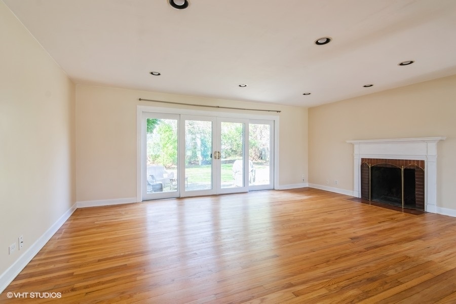 314 Wagner Road Northfield, IL 60093 - Photo 6 of 17 a view of an empty room with wooden floor and a window