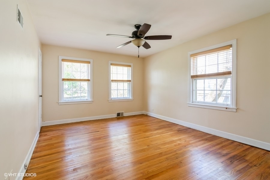 314 Wagner Road Northfield, IL 60093 - Photo 10 of 17 a view of an empty room with wooden floor and a window