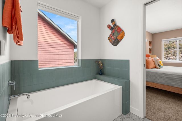 a bathroom with a bathtub and a window