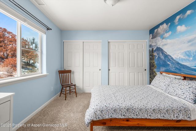 a bed sitting in a bedroom next to a window