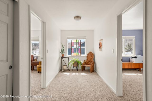a view of a bedroom with a bed and wooden floor