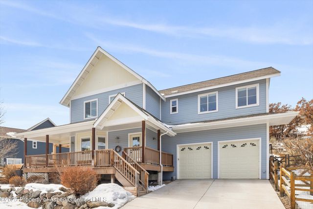 a view of a house with a wooden fence