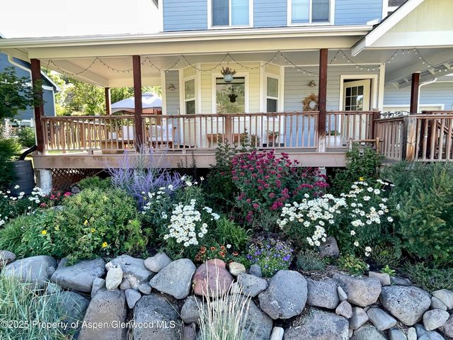 front view of a house with a flower garden