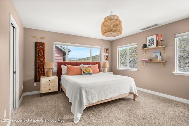 a bedroom with a large bed and a window