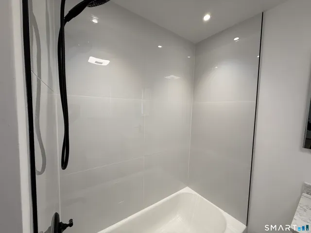 a bathroom with a shower and a sink