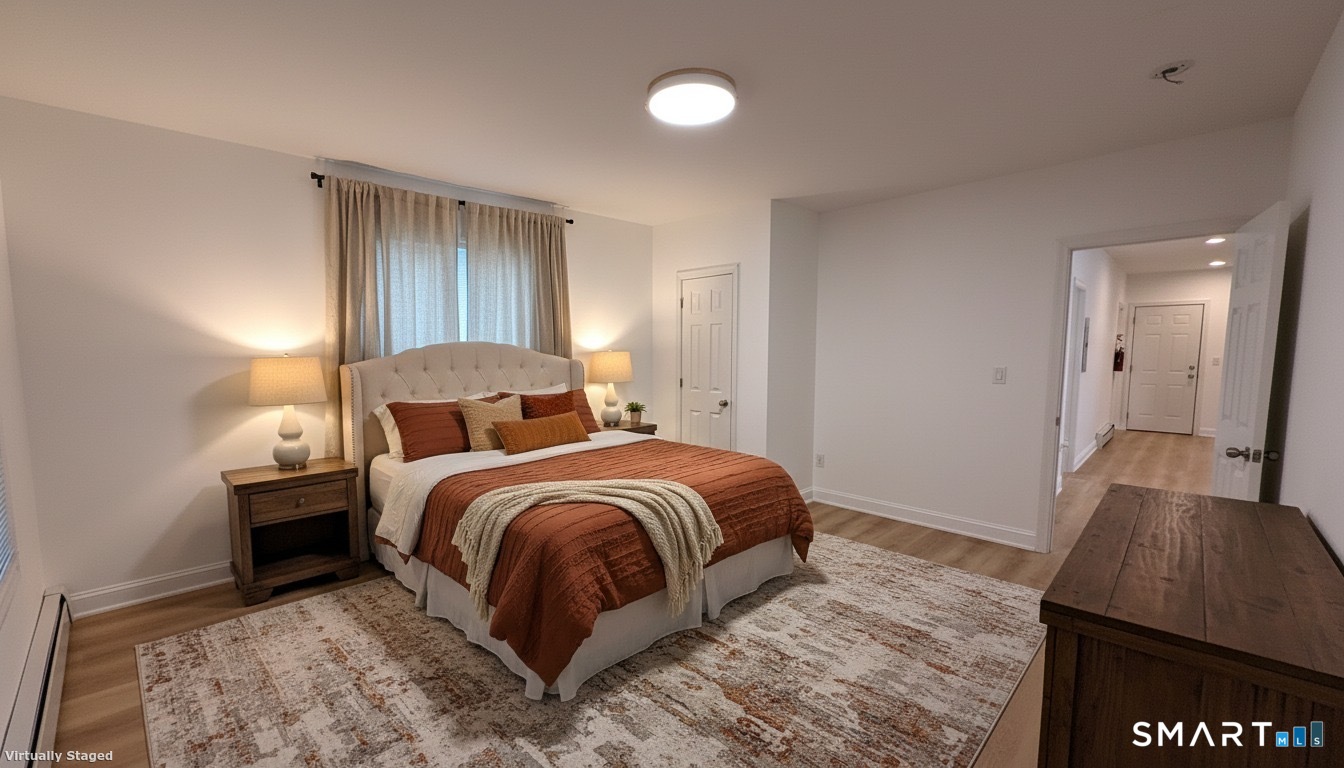 98 Franklin Avenue, Unit 1 Hartford, CT 06114 - Photo 7 of 7 a bedroom with a bed and wooden floor