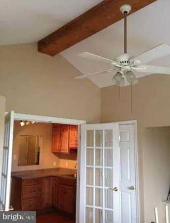 a view of a livingroom with a ceiling fan and wooden floor